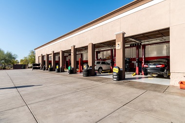 Open service bays with cars at Iconic Tire in Gilbert, Arizona